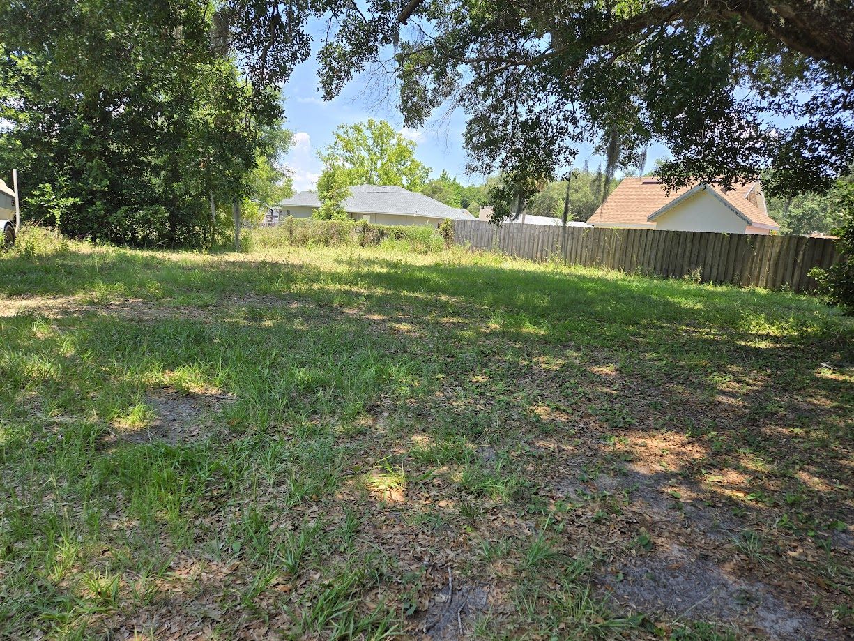 Ground-level view of the level, cleared corner parcel
